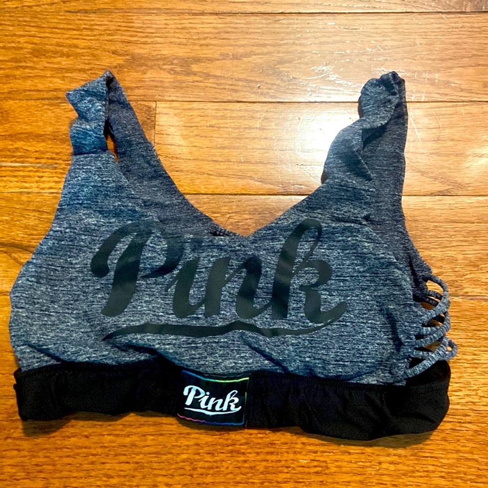 Pink brand scoop neck sports bra with cutout details on the back and sides.